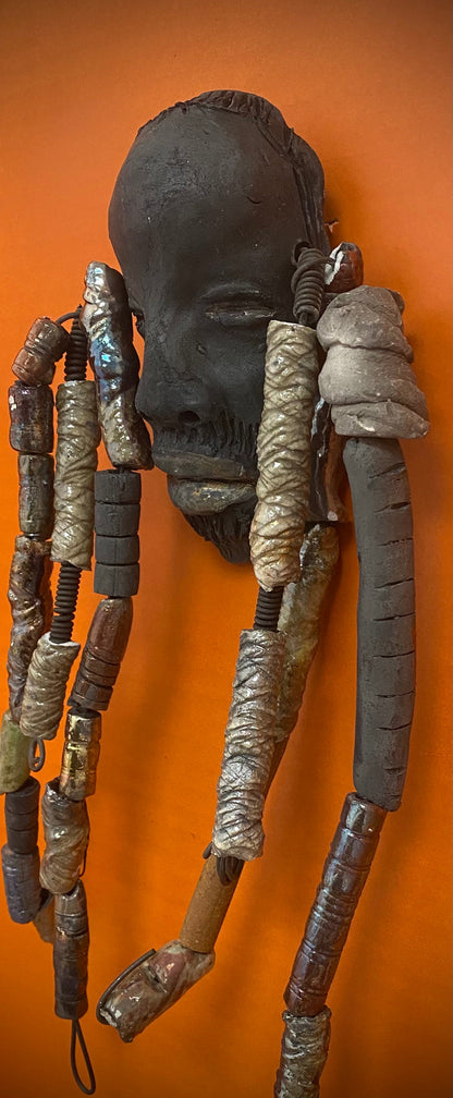 Meet Cain! You Like Wise men; You gotta Love Cain! I started making art soon after seeing authentic African artwork at the Smithsonian Museum of African Art. I was in total awe. Cole was inspired by my visit there.   Cain is a wise and distinguished  bearded gentleman who has a smoky dark complexion. He is approximately 5" x 11" and weighs 13 ozs. Cain has an aged hairstyle of more than 20 handmade textured clay dreadlocks along with twist of coiled 16 gauge wire.