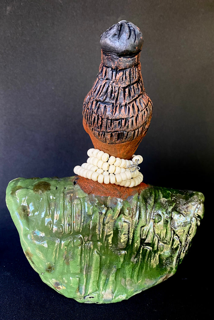 Meet Kayla!   Kayla looks ready  for an exciting evening out!  Kayla stands 6" x 5" x 3 and weighs 14 ozs. Kayla has a nice honey brown complexion and wears glasses. She wear etched clay hair styled in a bun. Kayla wears a textured white crackle robe. She is angelic! Kayla will make a great gift or starter piece from the Herdew Collection! Check out our Shipping and Return policy