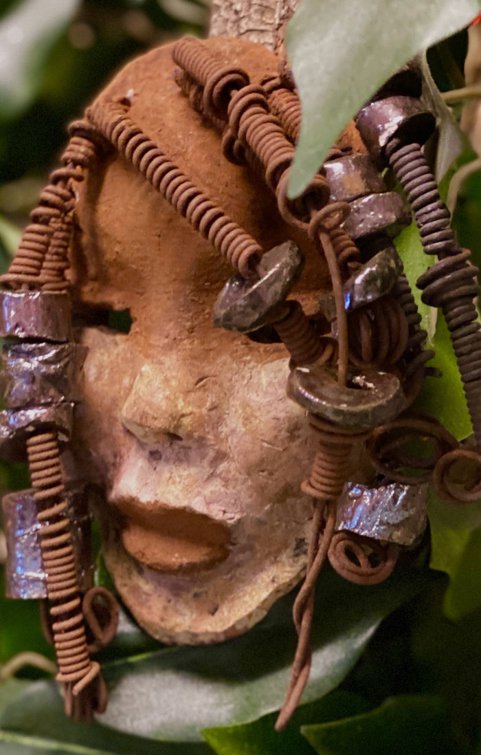 Macey  has a complexion of light and dark honey. She is 5" x 7" and weighs 1.1 lbs. Macey has over 20 handmade raku fired beads. She has over 15 feet of coiled 16 gauge wire hair.