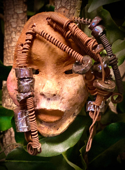 Macey  has a complexion of light and dark honey. She is 5" x 7" and weighs 1.1 lbs. Macey has over 20 handmade raku fired beads. She has over 15 feet of coiled 16 gauge wire hair.