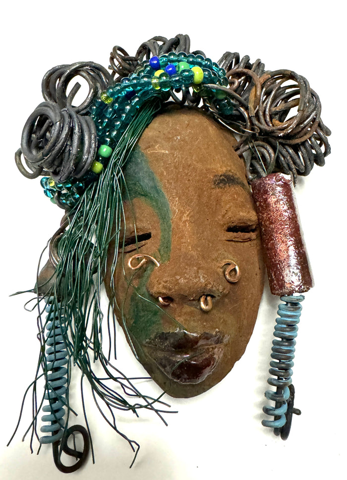 At 5" x 8" in size,  Marcel makes a stunning addition to walls, trees, and shadow boxes. His signature brown and amber braided hair is ornamented with handcrafted Raku beads, while his skin has a warm honey brown hue. Each piece is equipped with over 10 16 & 24-gauge wire in the hair. This fashionable sculpture will bring a modern flair to any room - simply place it in a shadow box and enjoy!