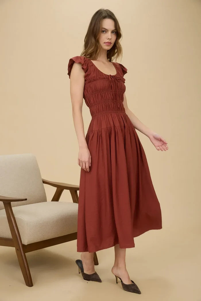 Rust-colored midi dress with shirred bodice, ruffle sleeve, and ruffled cap sleeves